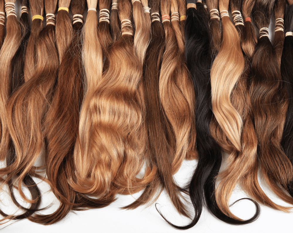An array of wigs displayed with a holistic approach to hair loss solutions, including natural and synthetic options.